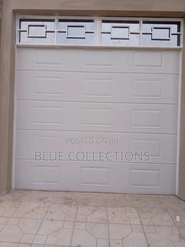 Automated Garage Door With Fanlight · Photo 1
