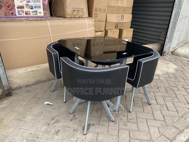 Modern Round Glass Dining Table Set With Four Chairs · Photo 2