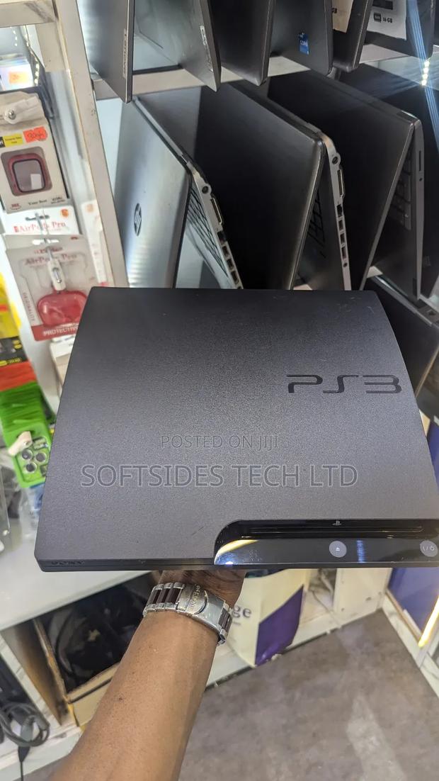 A Black Playstation 3 Slim With Games for Sale in Accra · Photo 1