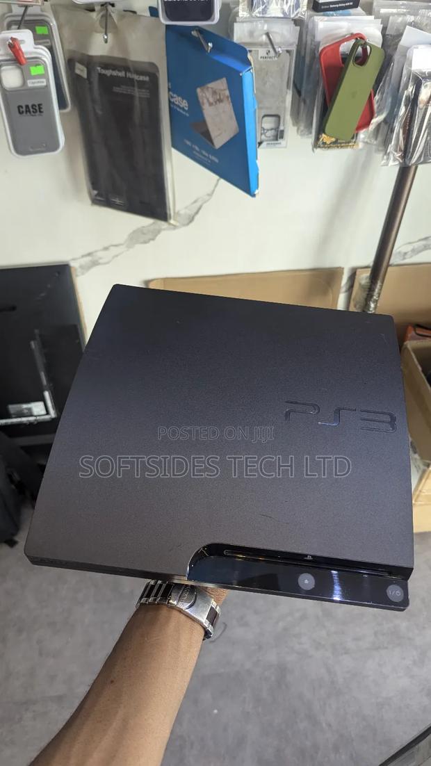 A Black Playstation 3 Slim With Games for Sale in Accra · Photo 4