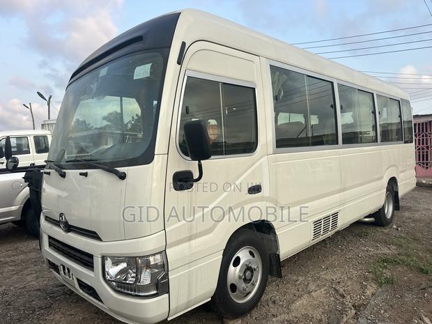New Toyota Coaster 2024 White · Photo 1
