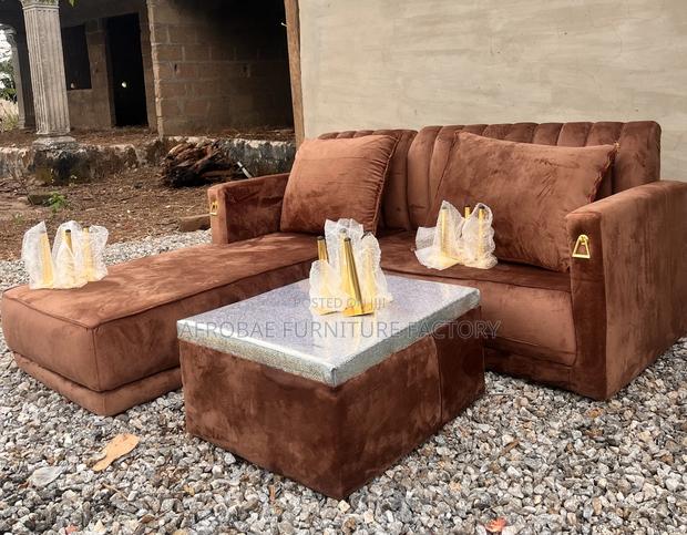 L - Shaped Sofa Chair With Quality Pillows and Polished Center Table · Photo 1