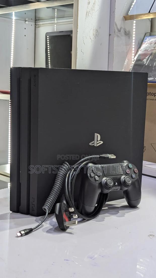 Very Neat Playstation 4 Pro With 15 Games and Accessories Shop Tested. · Photo 1