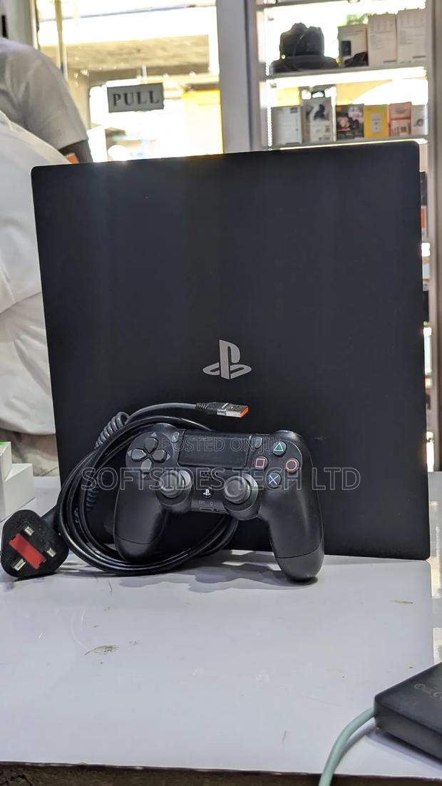 Very Neat Playstation 4 Pro With 15 Games and Accessories Shop Tested. · Photo 3