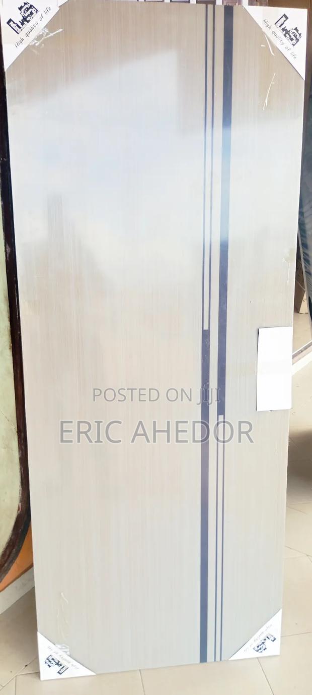 Smooth Wooden Door With Metal Frame and Handle · Photo 1