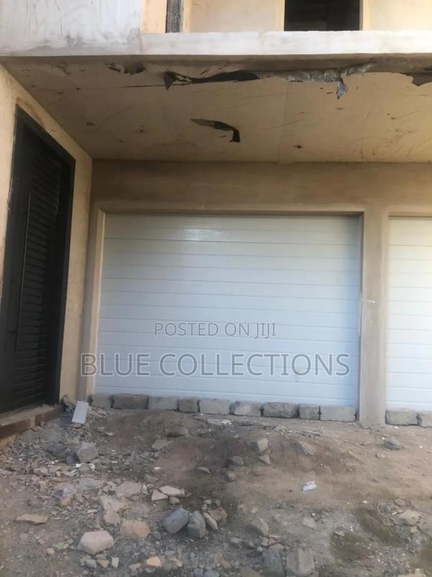 Straight Line Garage Door With Motor · Photo 1