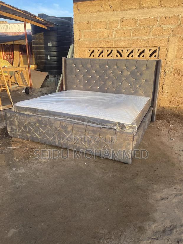 A Kingside Bed Frame With a Mattress · Photo 1