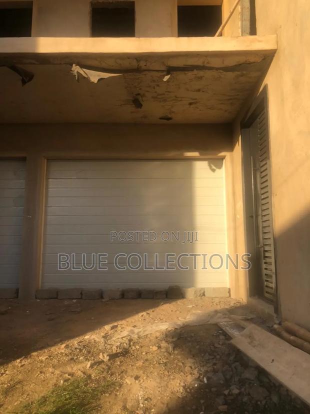 Straight Line Garage Door With Remote Opener · Photo 1