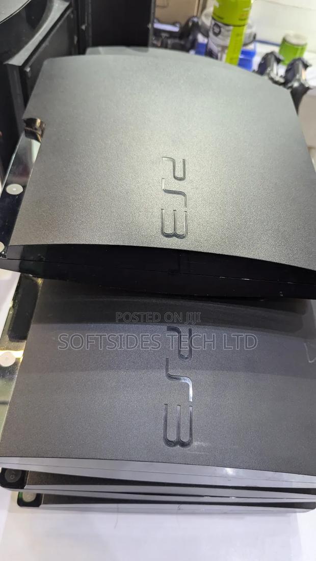 Black Playstation 3 Slim Cute Version With Games and a Controller · Photo 1