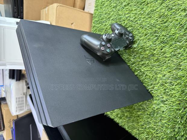 Playstation 4 Pro Console Display With One Controller and One Cd · Photo 8