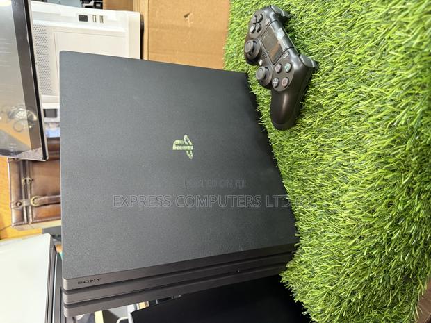 Playstation 4 Pro Console Display With One Controller and One Cd · Photo 6