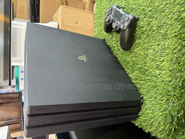 Playstation 4 Pro Console Display With One Controller and One Cd · Photo 1