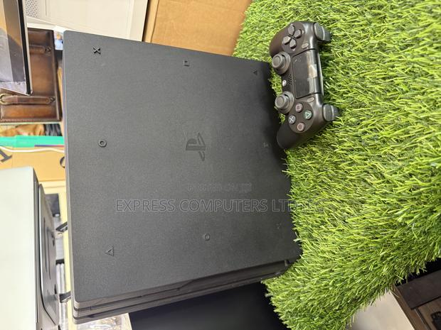 Playstation 4 Pro Console Display With One Controller and One Cd · Photo 7