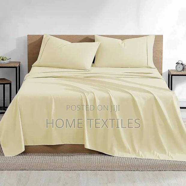 Cream Colored 2 Bedsheets and 4 Pillowcases 1 Fitted and 1 Flat Sheet · Photo 1