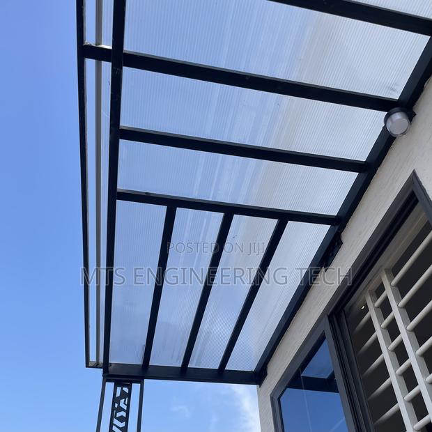 Modern Metal Shades With Polycarbonate Roofing · Photo 3