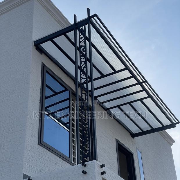 Modern Metal Shades With Polycarbonate Roofing · Photo 7