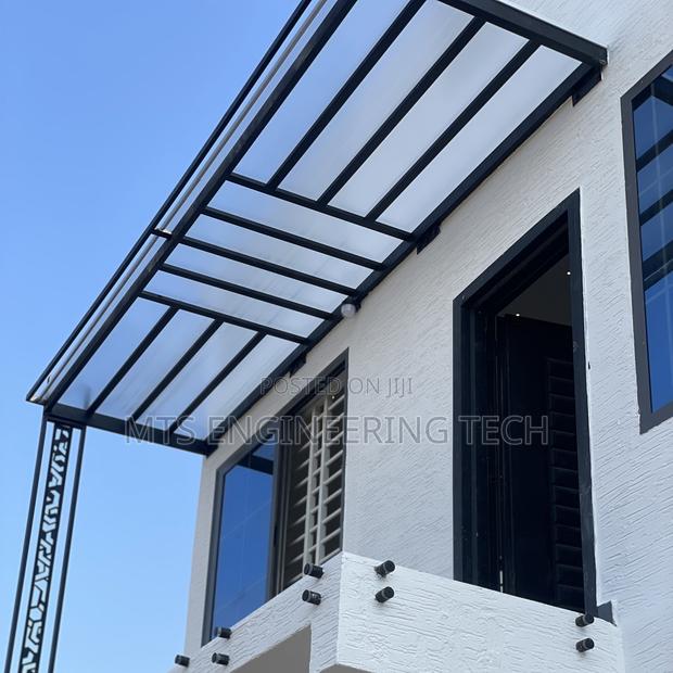 Modern Metal Shades With Polycarbonate Roofing · Photo 2