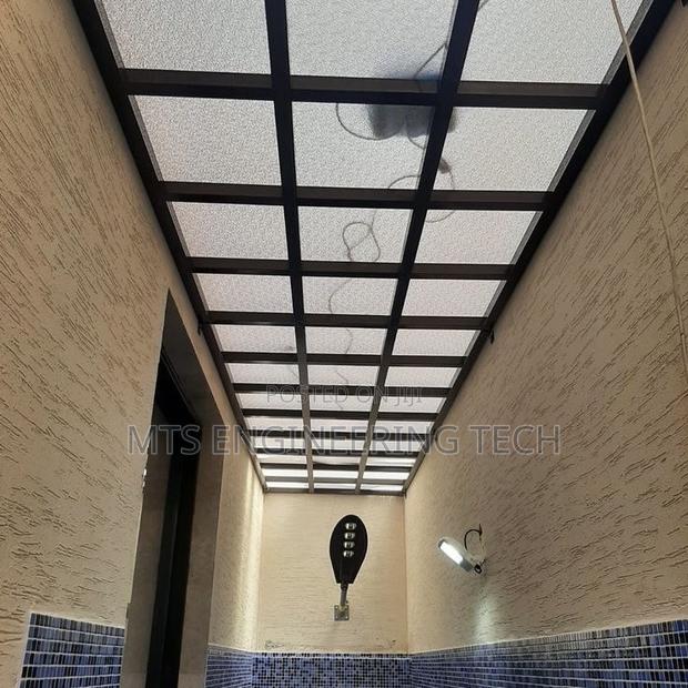 Modern Metal Shades With Polycarbonate Roofing · Photo 8