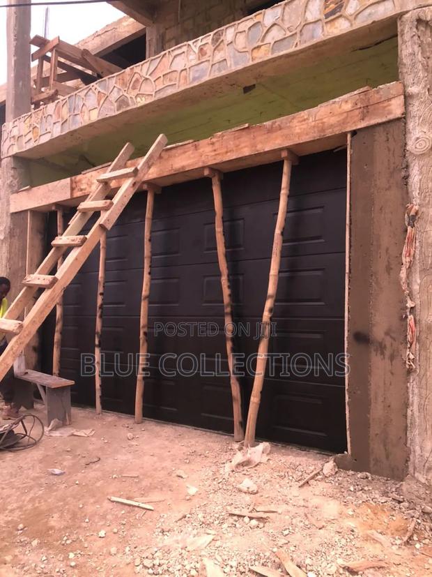 Black Automated Garage Door · Photo 1
