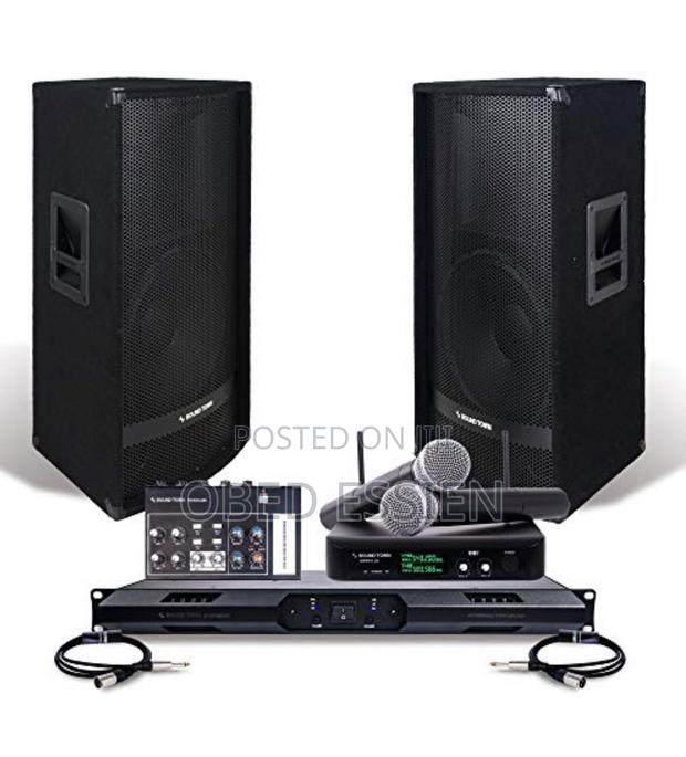 A Pair of JBL Speakers With Amp and Microphone