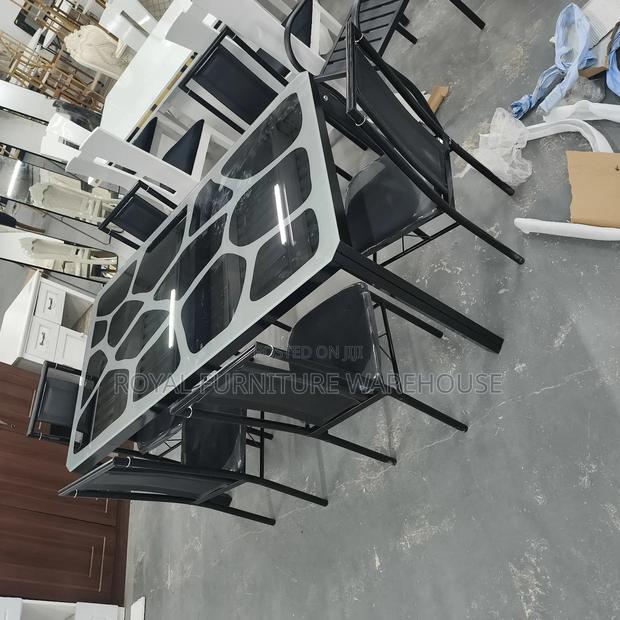 Modern Metal and Glass Dining Table Set With Six Black Chairs · Photo 1