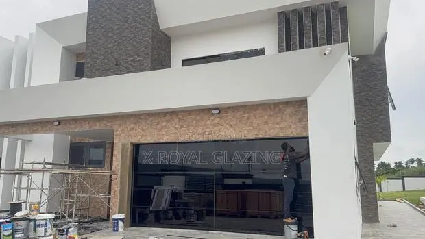 Modern Remote Control Frameless Glass Garage Door Well Installed · Photo 1