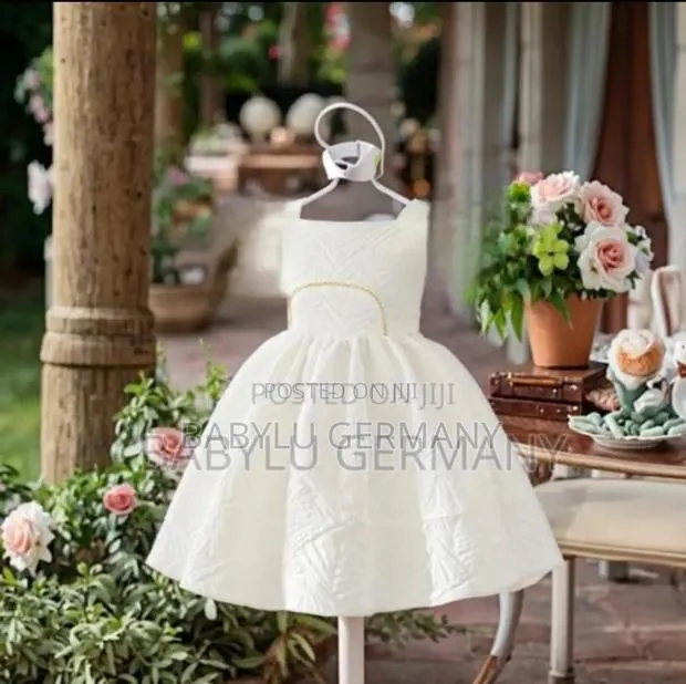 White Girl's Dress With Gold Pattern · Photo 1