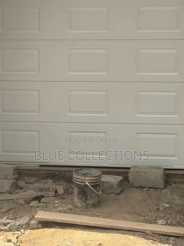 Automated Garage Door With Fanlight and Remote · Photo 1