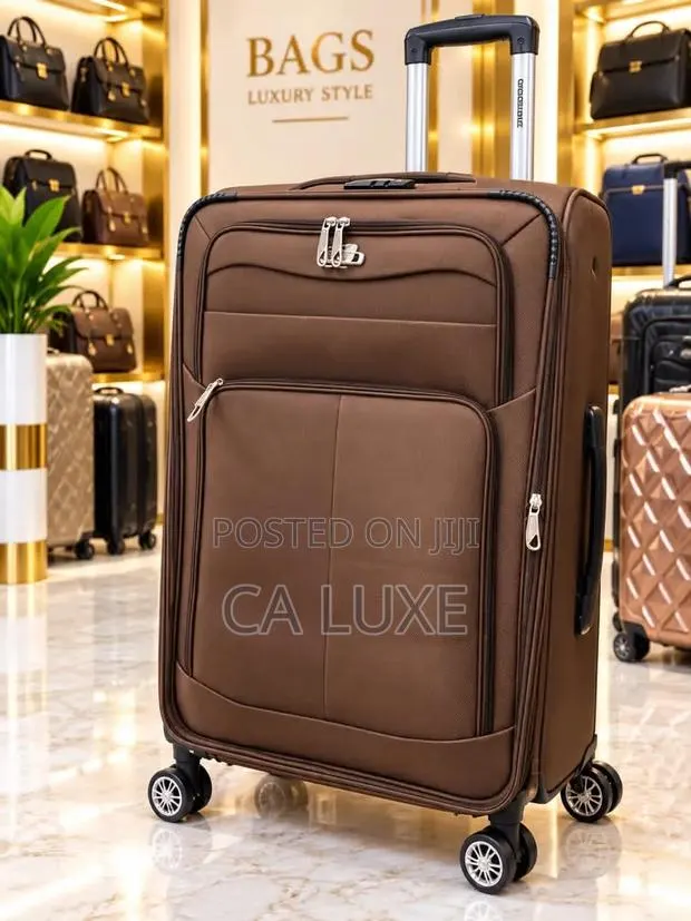 Brown Softside Fabric Suitcase With Zipper Compartments and Wheels · Photo 1