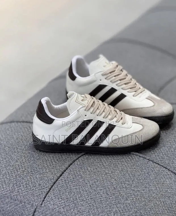 The Adidas Samba Sneakers Featuring a Clean White Leather Upper Paired · Photo 1