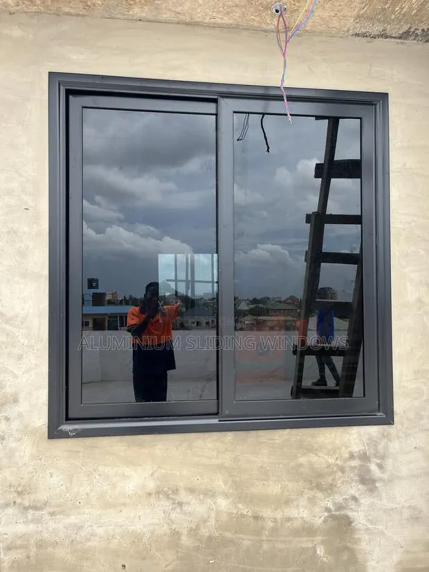 Ks50 Black Frame and Dark Glass Sliding Windows With Net and Locks · Photo 1