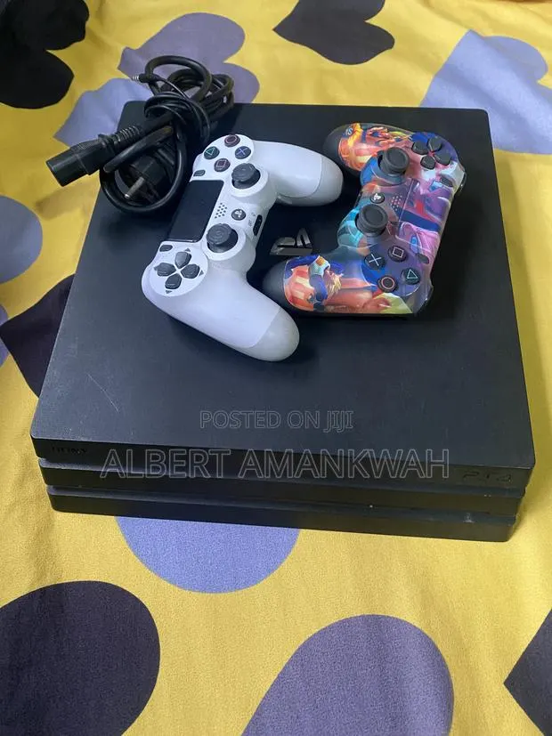 PS4 Pro 1TB With 2controllers and 8games Including FC27 · Photo 1