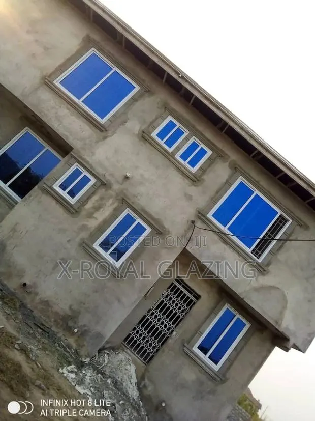 White Italian Frame Sliding Windows With Blue Glass. · Photo 1