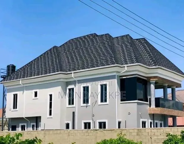 Black and White Shingles Euro Tiles and Rain Gutter · Photo 1