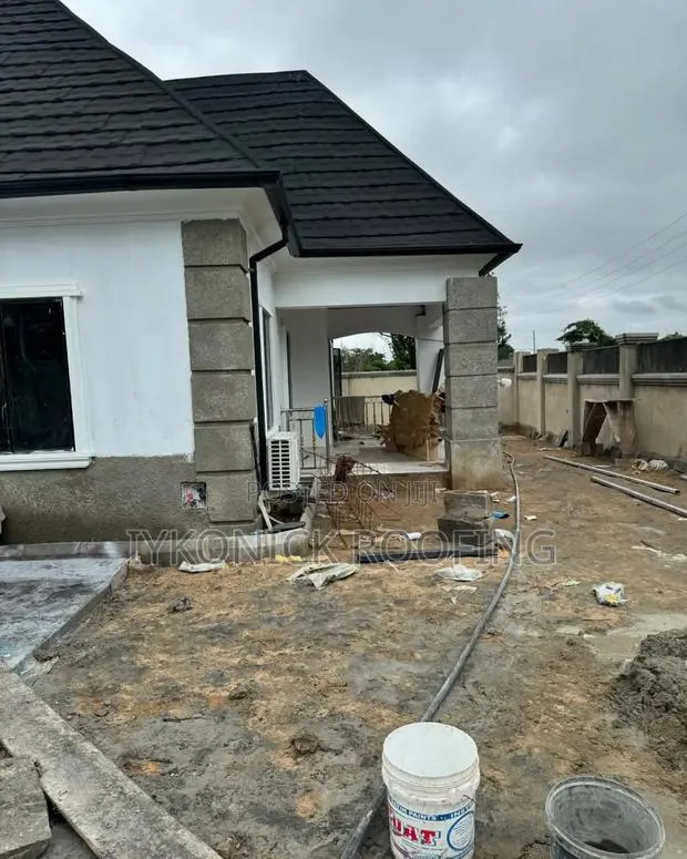 Euro Stone Coated Roofing Sheets and Rain Gutter Installation · Photo 1