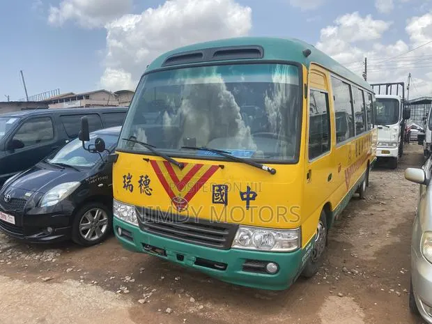 Toyota Coaster 2014 Yellow · Photo 1