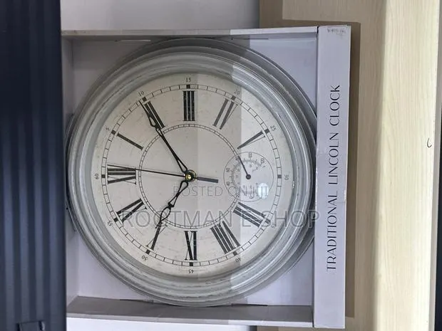 Home Collection Traditional Lincoln Wall Clock Featuring a Black Frame · Photo 1