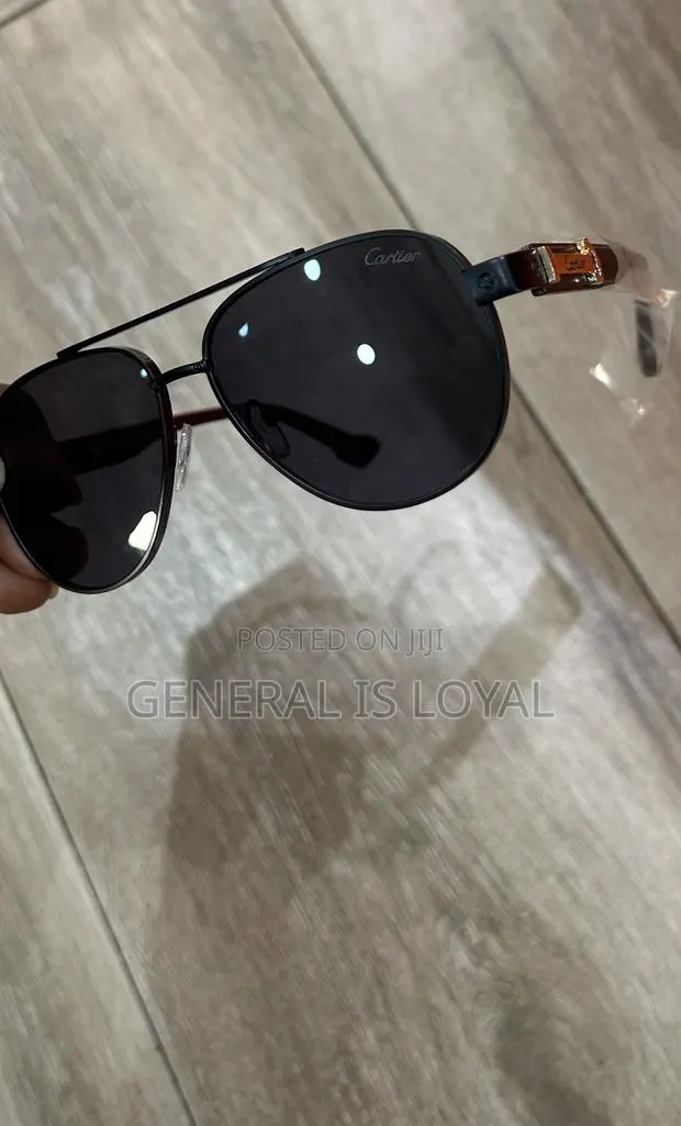 Cartier Aviator Sunglasses With A Black Metal Frame And Dark Lenses. · Photo 1