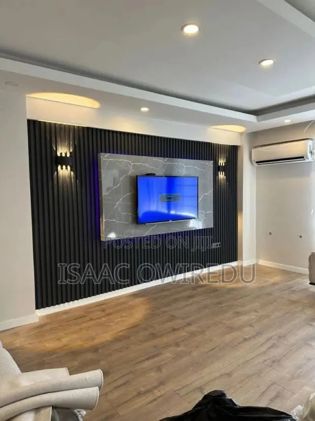 Television Wall Mounted Design With Colourful Lighting and Panels · Photo 1