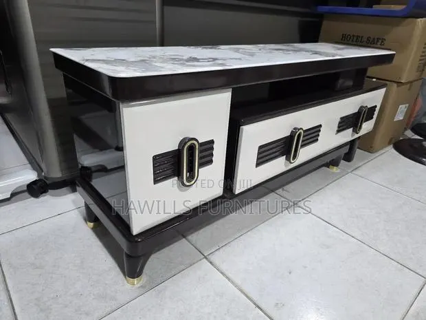 Tv Stand Featuring Gold Accents · Photo 1