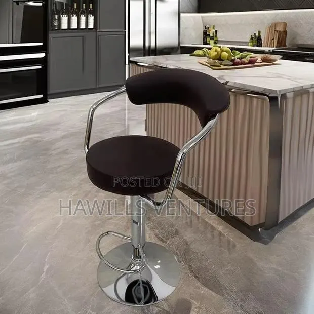 Swivel Bar Stool Featuring a Padded Seat and a Chrome Base. · Photo 1