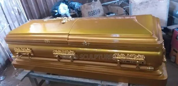 Gold Gloss Casket With Ornate Handles · Photo 1