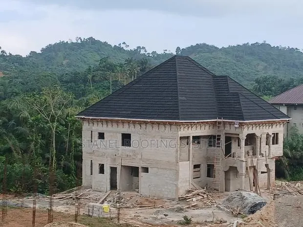 Black Quality Roofing Sheets and Rain Gutters Installations · Photo 1