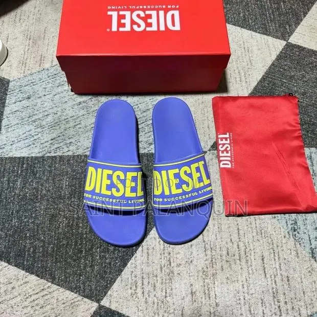 A Pair of Blue Diesel SA-Mayemi CC Slide Sandals · Photo 1