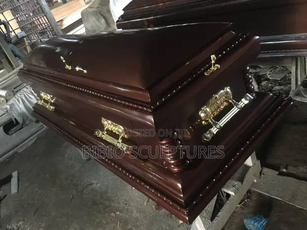Mahogany-Finish Casket With Carved Pillars · Photo 1