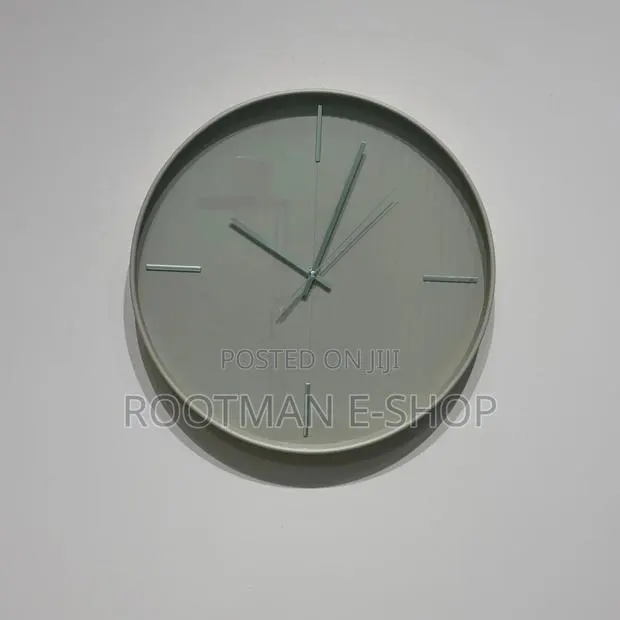 Circular Wall Clock Featuring a Minimalist, Grey-Toned Design · Photo 1