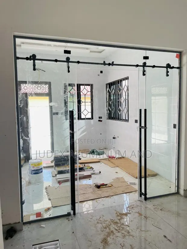 Frameless Double Sliding Doors With Black Accessories · Photo 1