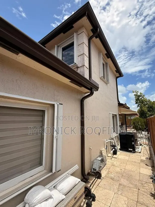 PVC Rain Gutters Installation Downspout Equipment · Photo 1