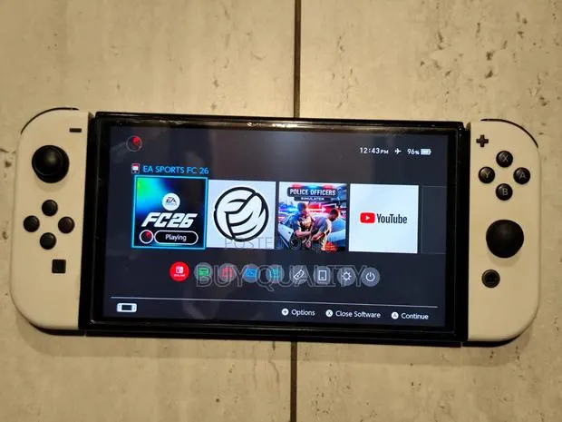 Nintendo Switch Oled With FC26 Game Card and Original Charger. · Photo 1