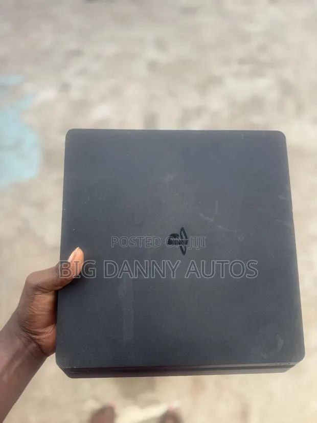 PlayStation 4 Slim With Games and Controls · Photo 1